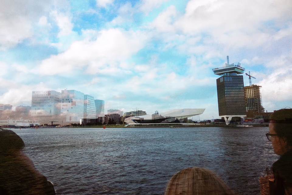 Double exposure of Amsterdam waterfront, Eye Filmmuseum and overcast sky, Netherlands