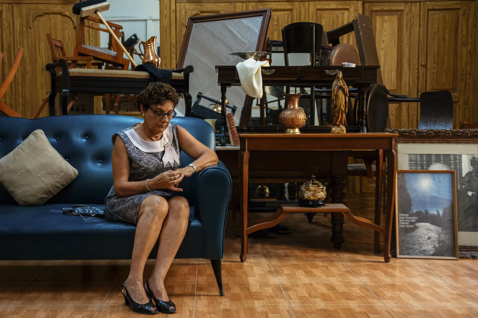 Woman watching time pass, seated on a couch in an Old theatre, conceptual digital photography, 'Linji Sfużi' - a collection of short stories and photography