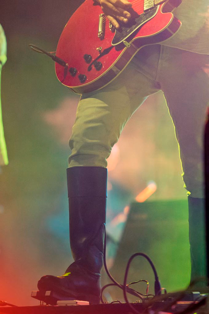 Singer at microphone, green stage light, close crop, Airport Impressions, Beland Festival
