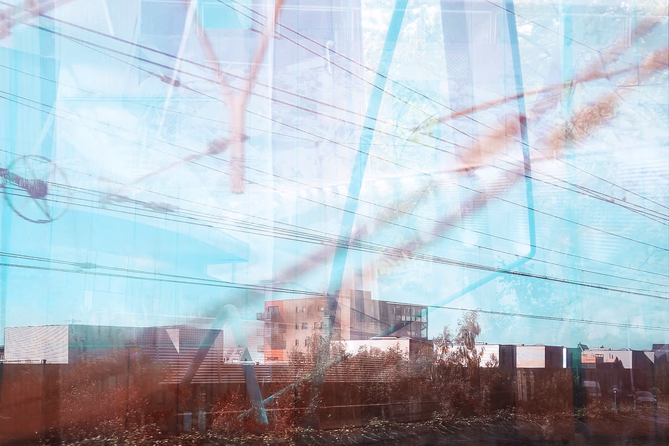 Multiple exposure of power lines and urban infrastructure, teal and red tones, Netherlands memory series