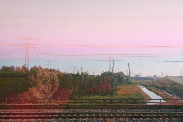 Multiple exposure of reed field and figure in pink haze, Netherlands, memory series, digital collage